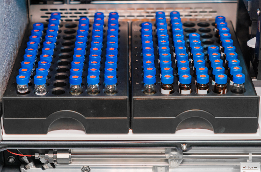 HPLC glass vials in the rack. Research and development of pharmaceuticals and vaccines. High performance liquid chromatography at analytical chemistry laboratory
